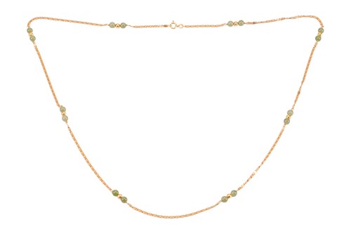 Lot 114 - A long scroll link chain with nephrite bead...