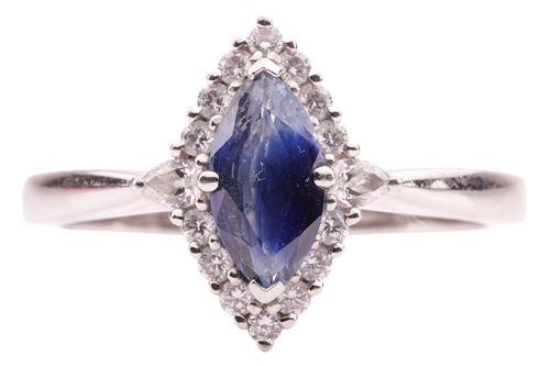Lot 126 - A sapphire and diamond halo ring in platinum,...