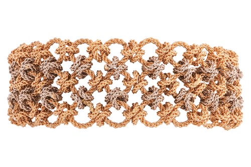 Lot 183 - A two-toned interwoven link bracelet, leading...