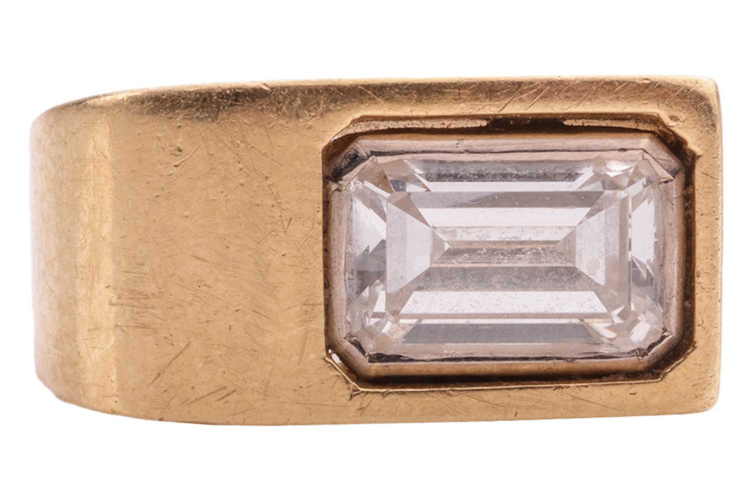 Lot 234 - A Modernist diamond-set ring; the emerald-cut...