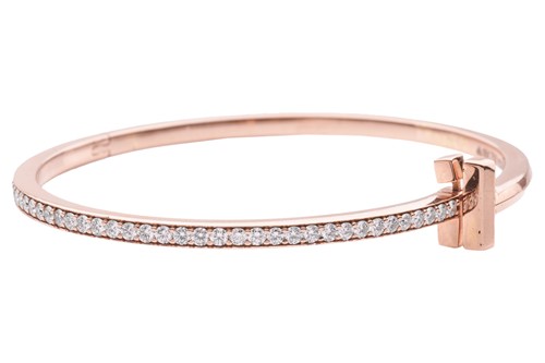 Lot 56 - A diamond-set hinged bangle, in the style of...