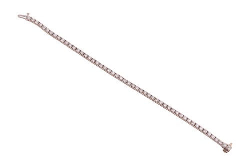 Lot 52 - A diamond line bracelet, with an estimated...