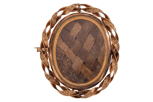 Lot 95 - A Victorian hairwork mourning brooch, of oval...