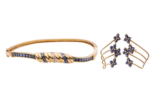 Lot 185 - A sapphire and diamond-set hinged bangle, the...