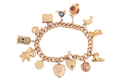 Lot 174 - A 9ct charm bracelet, decorated with thirteen...