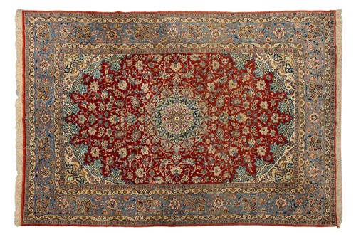 Lot 108 - A laquer red ground Isfahan carpet with...