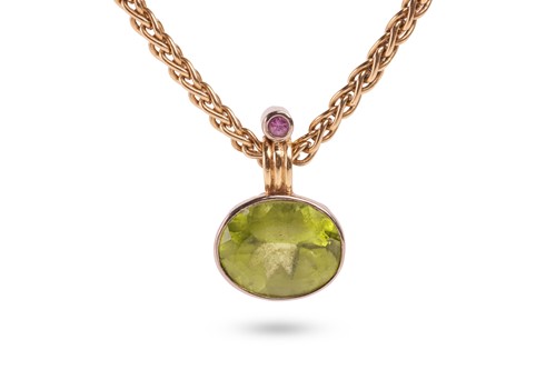 Lot 23 - A gem-set pendant, featuring an oval-cut...