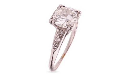 Lot 156 - A diamond solitaire ring; comprising a central...