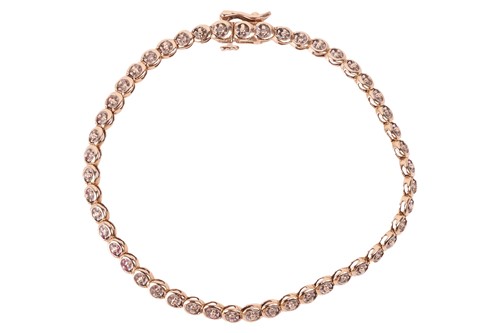 Lot 203 - A diamond-set line bracelet; featuring...