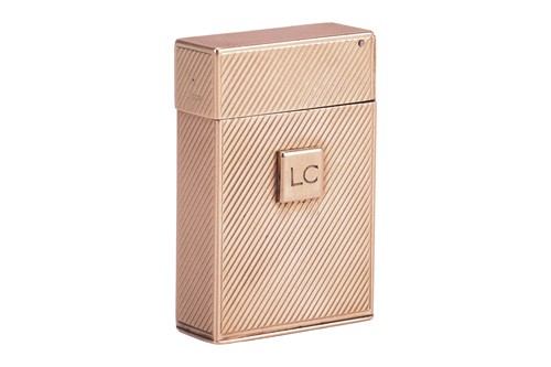 Lot 312 - Cartier - a 9ct gold lighter, of upright...