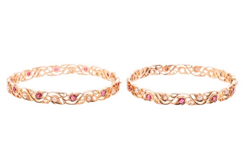 Lot 53 - A pair of hinged bangles set with seed pearls...