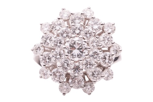 Lot 38 - A diamond cluster ring, comprising a central...