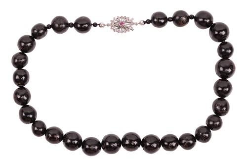 Lot 144 - A black horn bead necklace; featuring round...