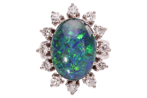 Lot 28 - An opal triplet and diamond cluster ring, the...