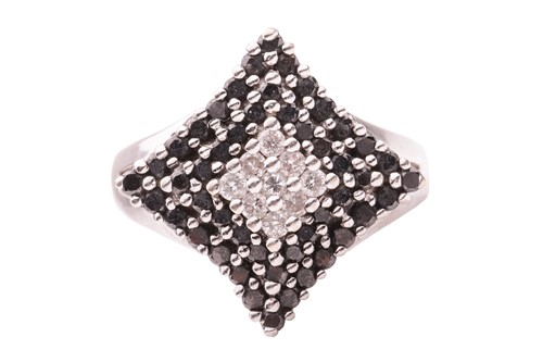 Lot 197 - A white and black diamond dress ring; set with...