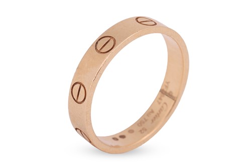 Lot 223 - Cartier - an 18ct yellow gold "Love" ring; the...