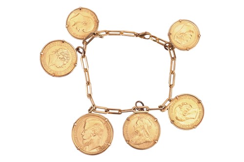 Lot 50 - A charm bracelet, comprising a series of flat...
