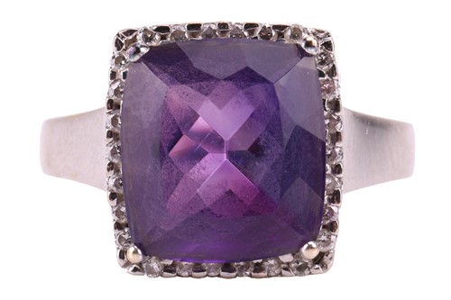 Lot 68 - An amethyst and diamond cluster dress ring in...