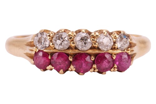 Lot 64 - A ruby and diamond dress ring; featuring a row...