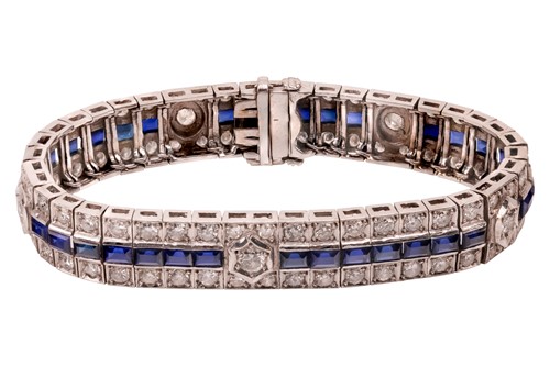 Lot 110 - A synthetic sapphire and diamond line bracelet,...