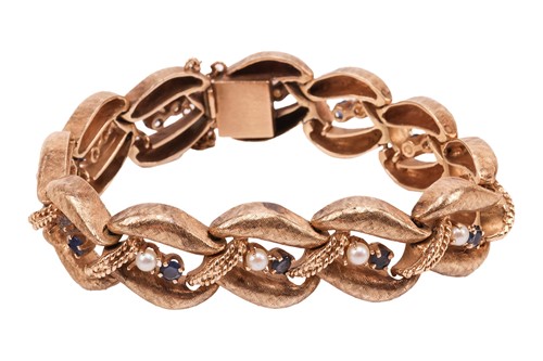 Lot 56 - A gem-set bracelet, the curved links with...