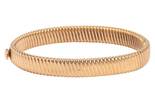 Lot 180 - A reeded hinged bangle, two hollow halves with...