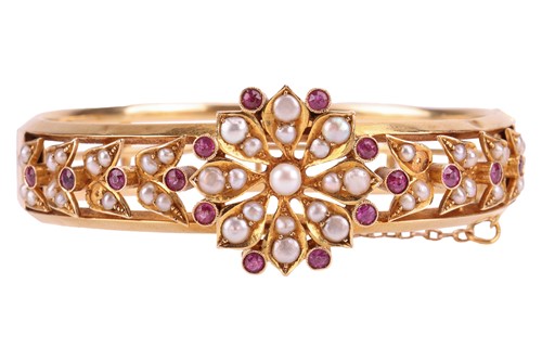 Lot 232 - A late 19th-century gem-set hinged bangle,...