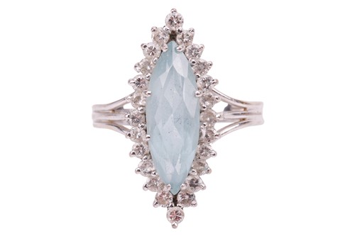 Lot 98 - An aquamarine and diamond halo ring in 18ct...