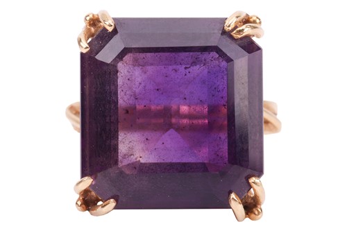Lot 57 - An amethyst cocktail ring, containing a large...