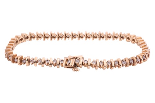 Lot 83 - A diamond-set line bracelet; comprising...