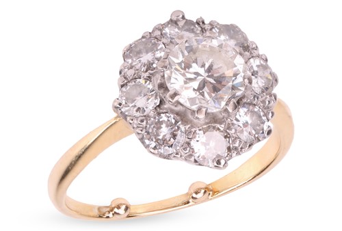 Lot 193 - A diamond daisy head cluster ring, with an...