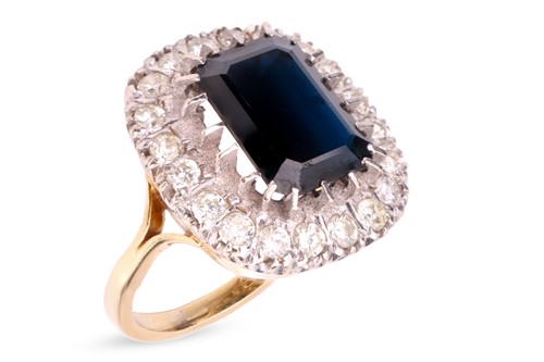 Lot 20 - A sapphire and diamond cluster ring in 18ct...