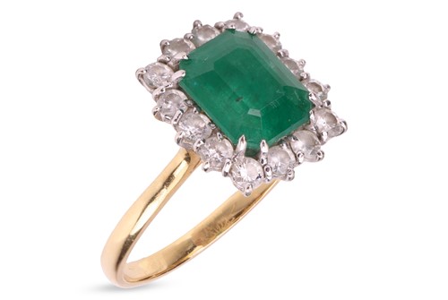 Lot 161 - An emerald and diamond cluster ring in 18ct...