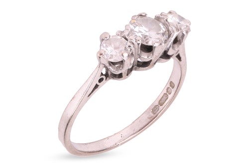 Lot 105 - A diamond three-stone ring in 18ct white gold,...