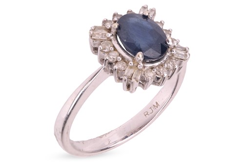 Lot 199 - A sapphire and diamond cluster ring,...