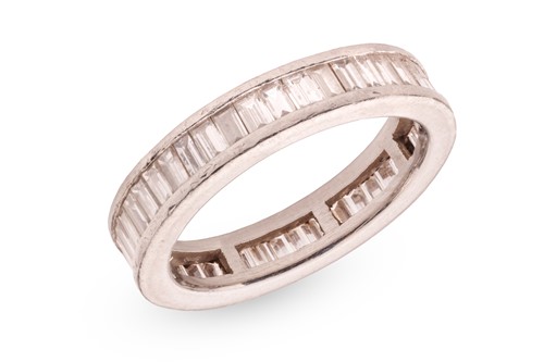 Lot 147 - A diamond eternity ring, channel-set with an...