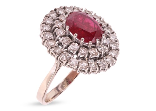 Lot 56 - A ruby and diamond cluster ring, centred with...