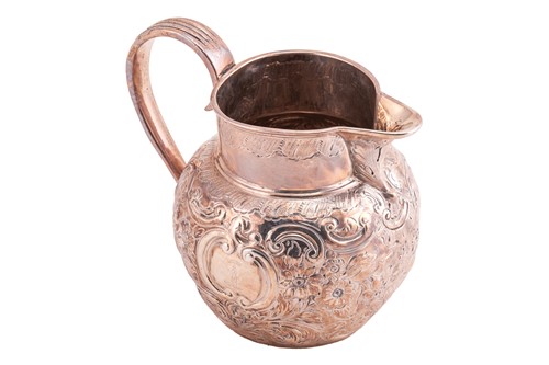 Lot 321 - A silver jug with floral repoussework,...