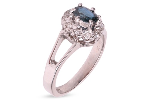 Lot 171 - A sapphire and diamond cluster ring in 18ct...