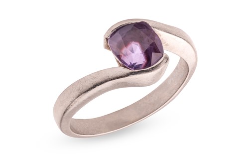 Lot 154 - A purple sapphire crossover ring, featuring a...