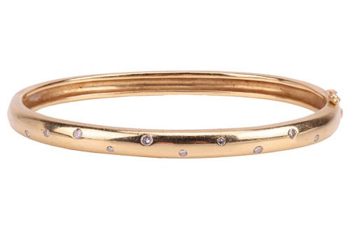 Lot 102 - A diamond-set hinged bangle, the front...