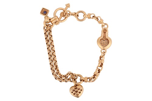 Lot 104 - A diamond-set heart charm bracelet in 18ct...