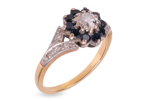 Lot 206 - A sapphire and diamond cluster ring, centred...