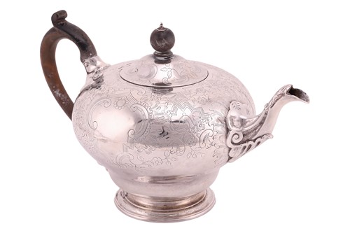 Lot 343 - A silver teapot of baluster shape, with carved...
