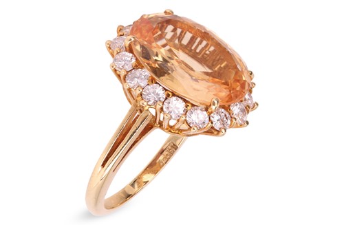 Lot 330 - A topaz and diamond cluster ring; comprising a...