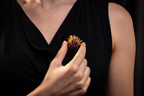 Lot 67 - A Modernist brooch set with pink sapphire and...