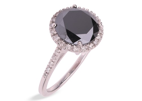 Lot 173 - A black diamond halo ring, centred with a...