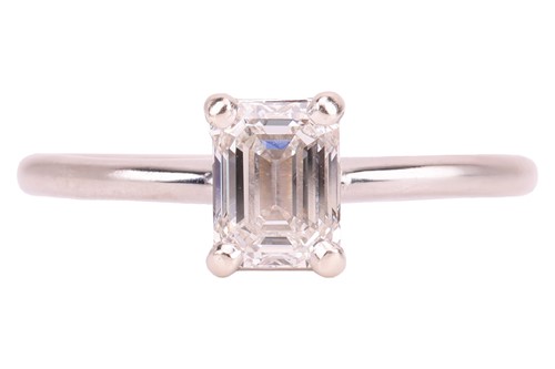 Lot 40 - An emerald-cut diamond solitaire ring in 14ct...