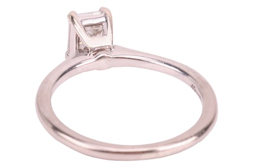 Lot 40 - An emerald-cut diamond solitaire ring in 14ct...