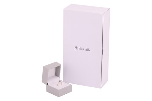 Lot 40 - An emerald-cut diamond solitaire ring in 14ct...